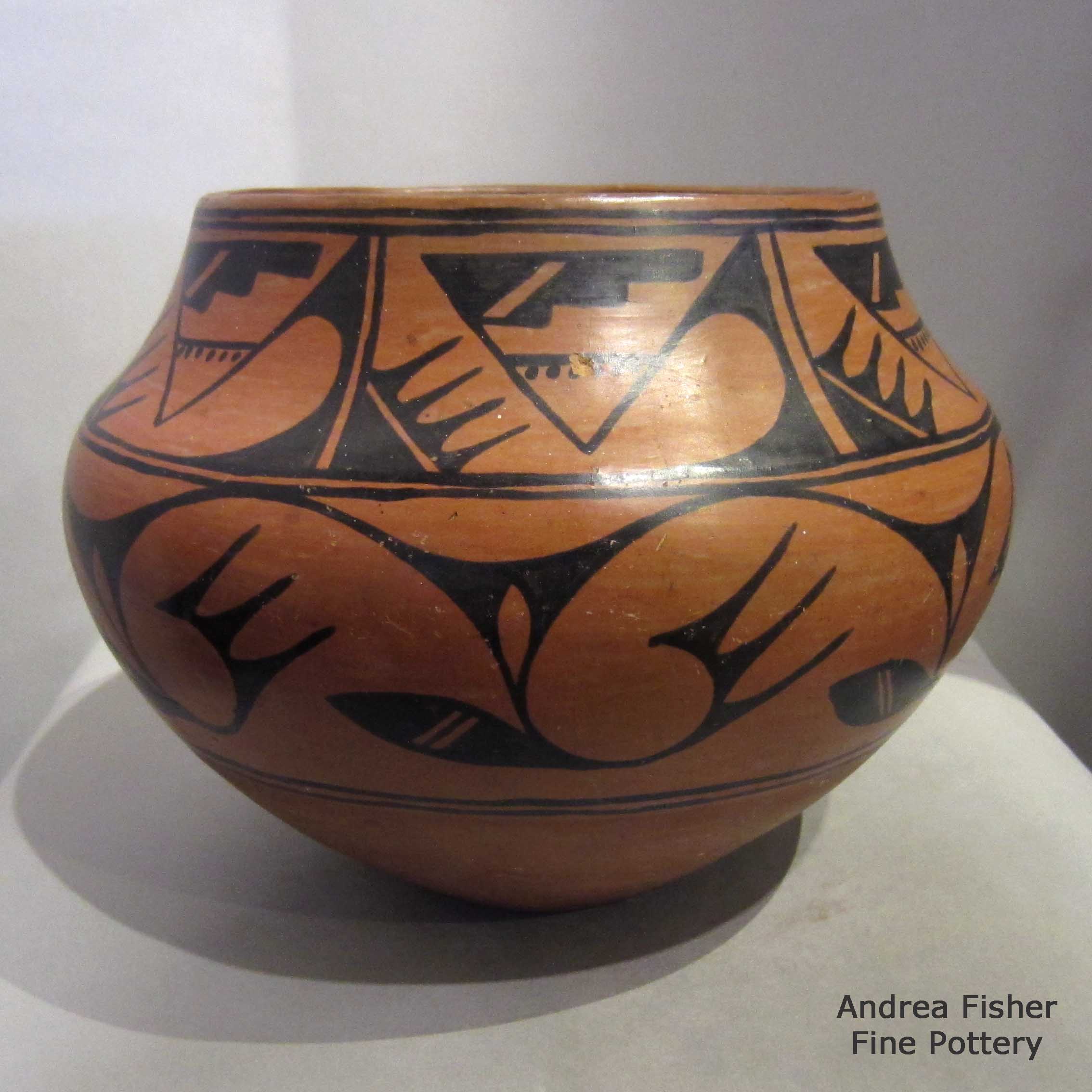 Click or tap to see a larger view Black on red storage jar with geometric design made by Tonita Roybal of San Ildefonso