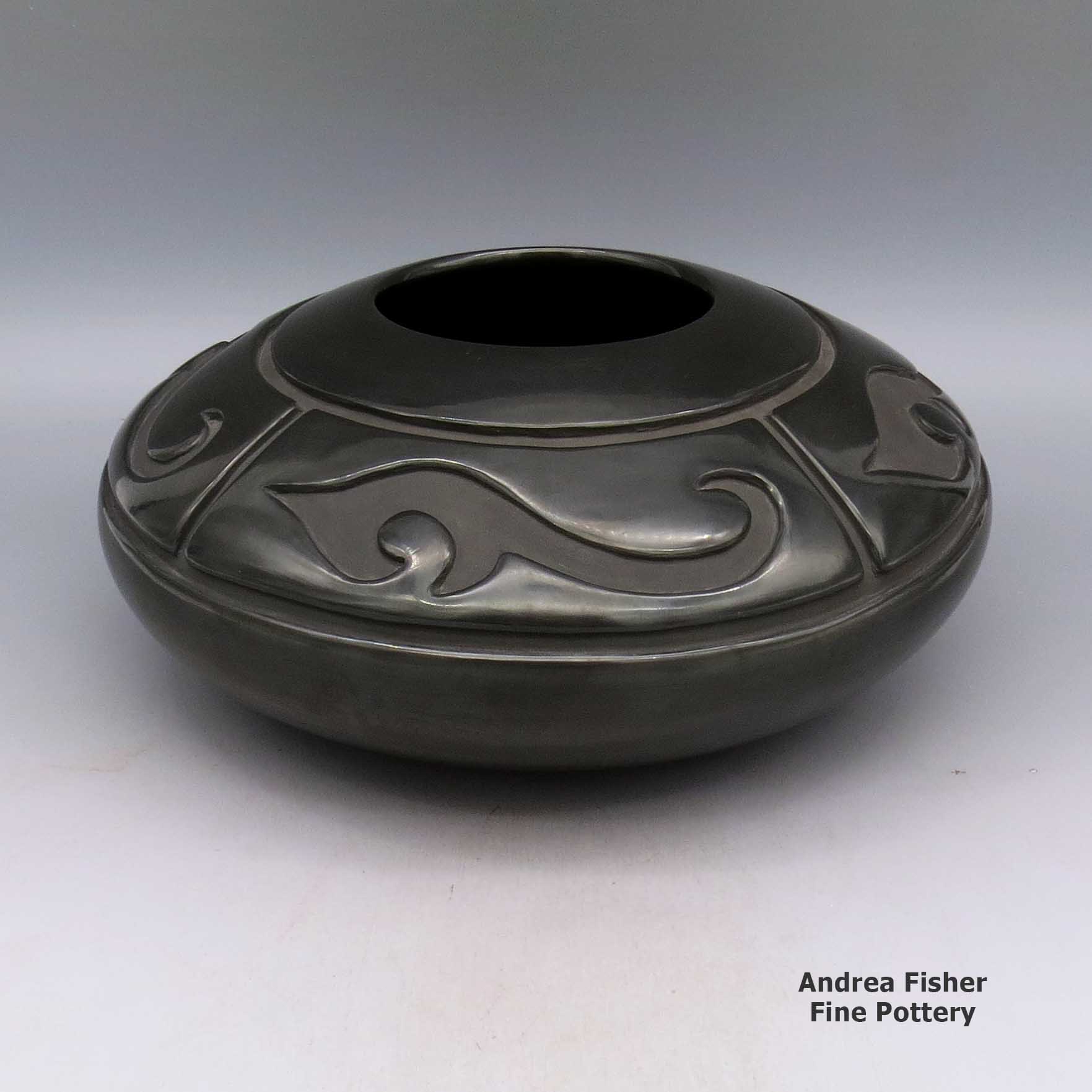 Click or tap to see a larger view Black jar with carved four panel geometric design made by LuAnn Tafoya of Santa Clara