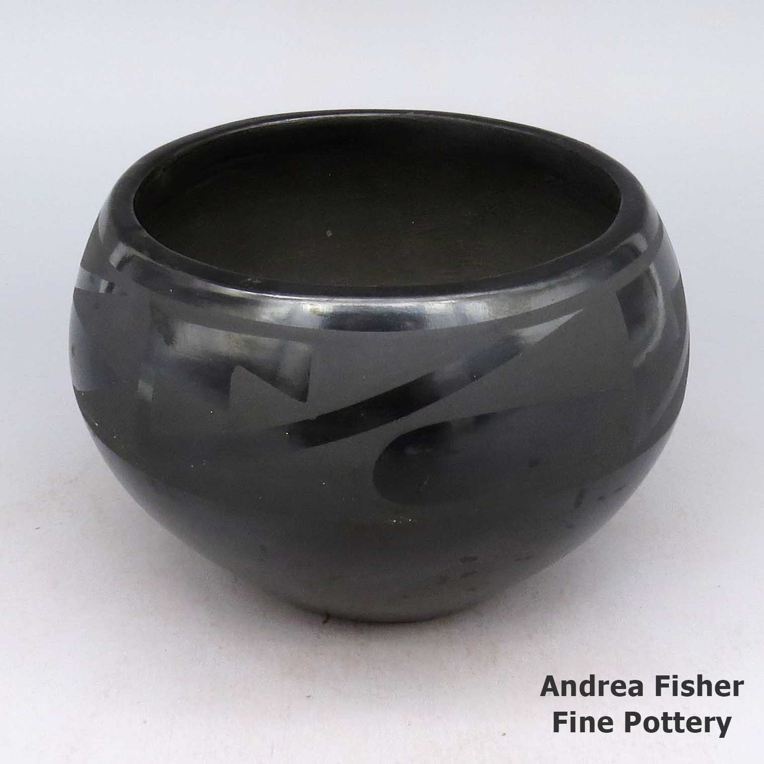 Black bowl with four panel geometric design made by Tonita Roybal of San Ildefonso