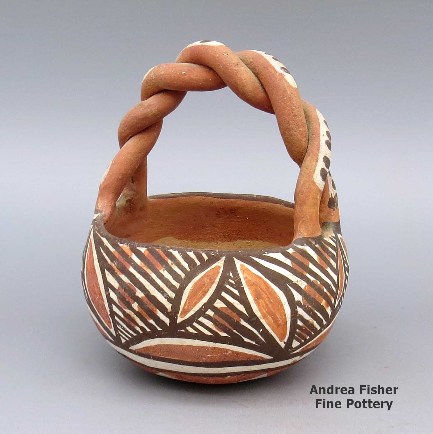 Polychrome friendship basket with twisted handle and geometric design made by Unknown of Isleta