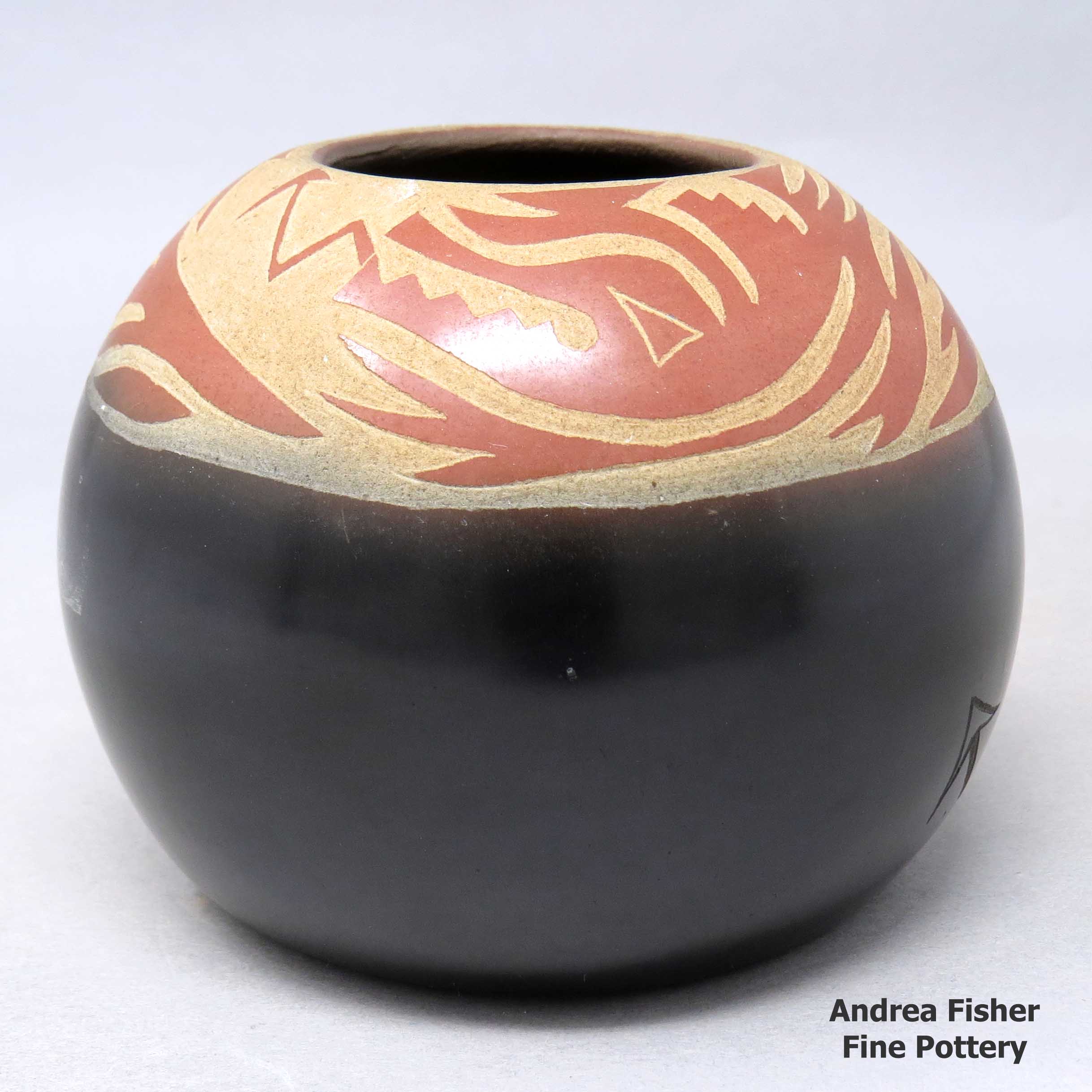 Click or tap to see a larger view Red and black jar with sgraffito avanyu designs
made by Grace Medicine Flower of Santa Clara