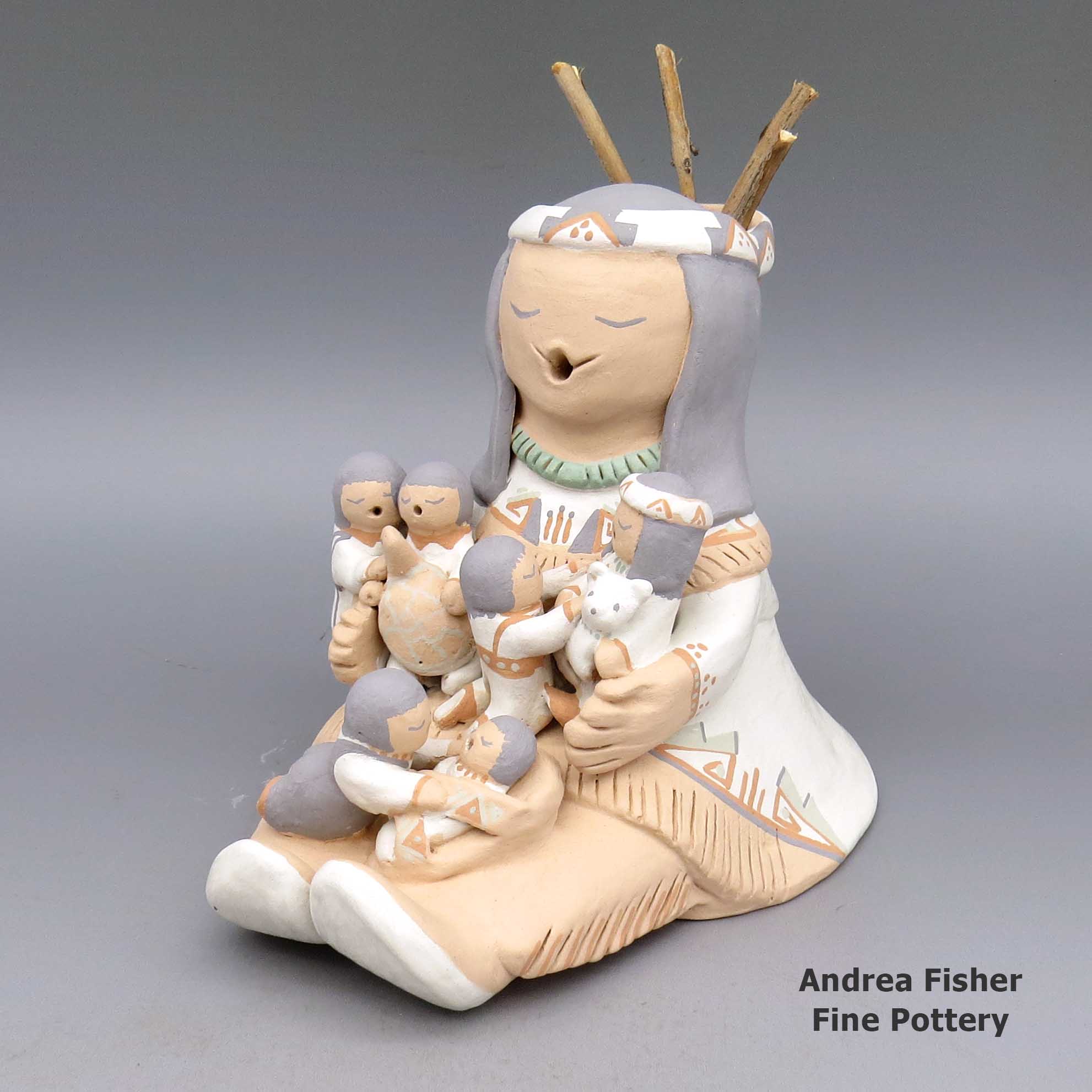 Click or tap to see a larger view Polychrome storyteller with six children and drum made by Stella Teller of Isleta
