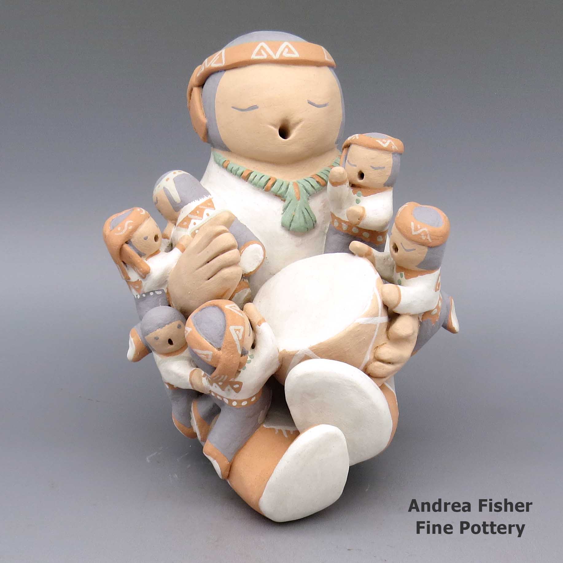 Click or tap to see a larger view Polychrome storyteller with six children, turtle, puppy, and sticks made by Stella Teller of Isleta