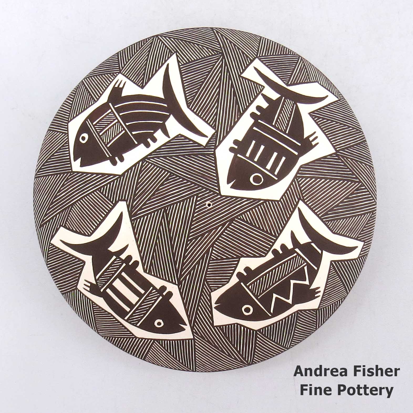 Black and white seed pot with a Mimbres fish and geometric design made by Rebecca Lucario of Acoma