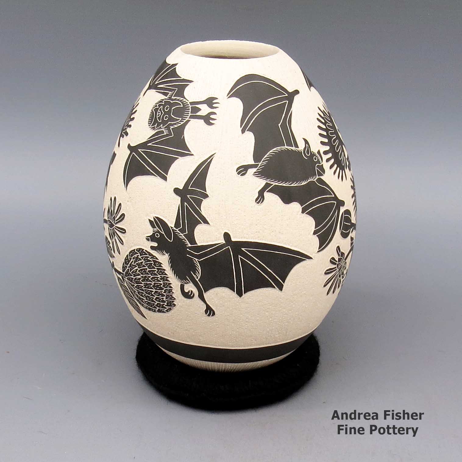 Black and white jar with sgraffito bat and flower design made by Adrian Corona of Mata Ortiz and Casas Grandes