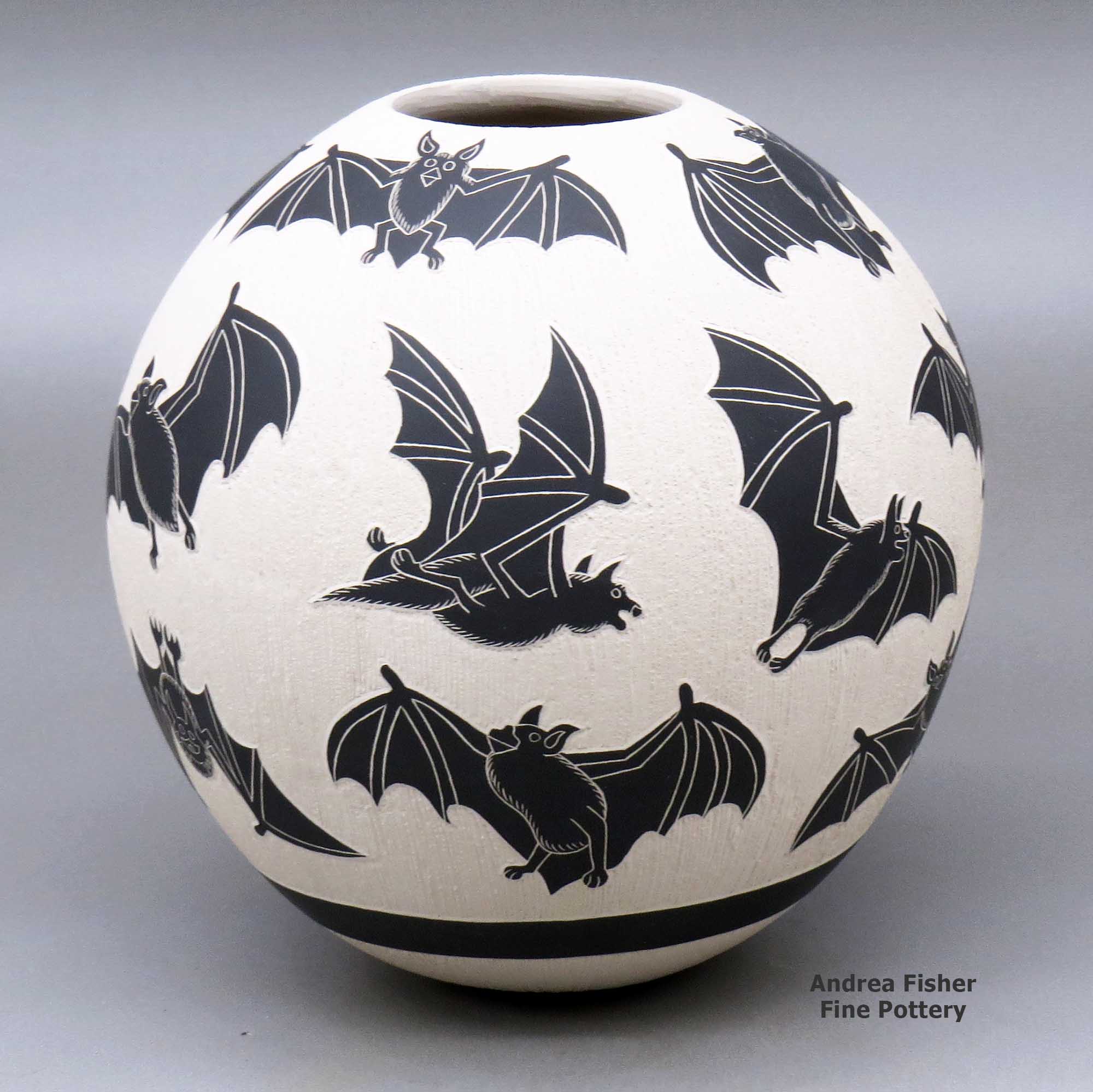 Click or tap to see a larger view Black and white jar with sgraffito bat and flower design made by Adrian Corona of Mata Ortiz and Casas Grandes