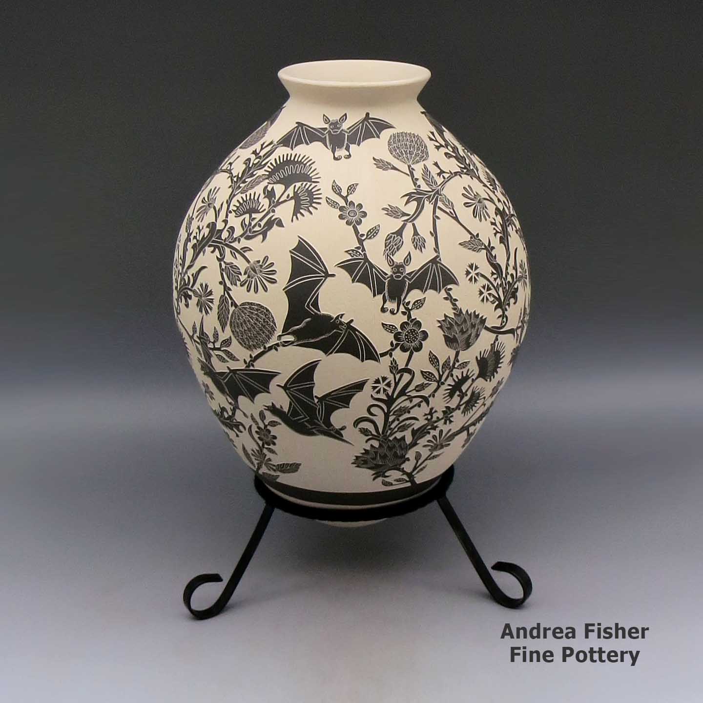 Large black and white jar with flared rim and sgraffito bat and flower design made by Adrian Corona of Mata Ortiz and Casas Grandes