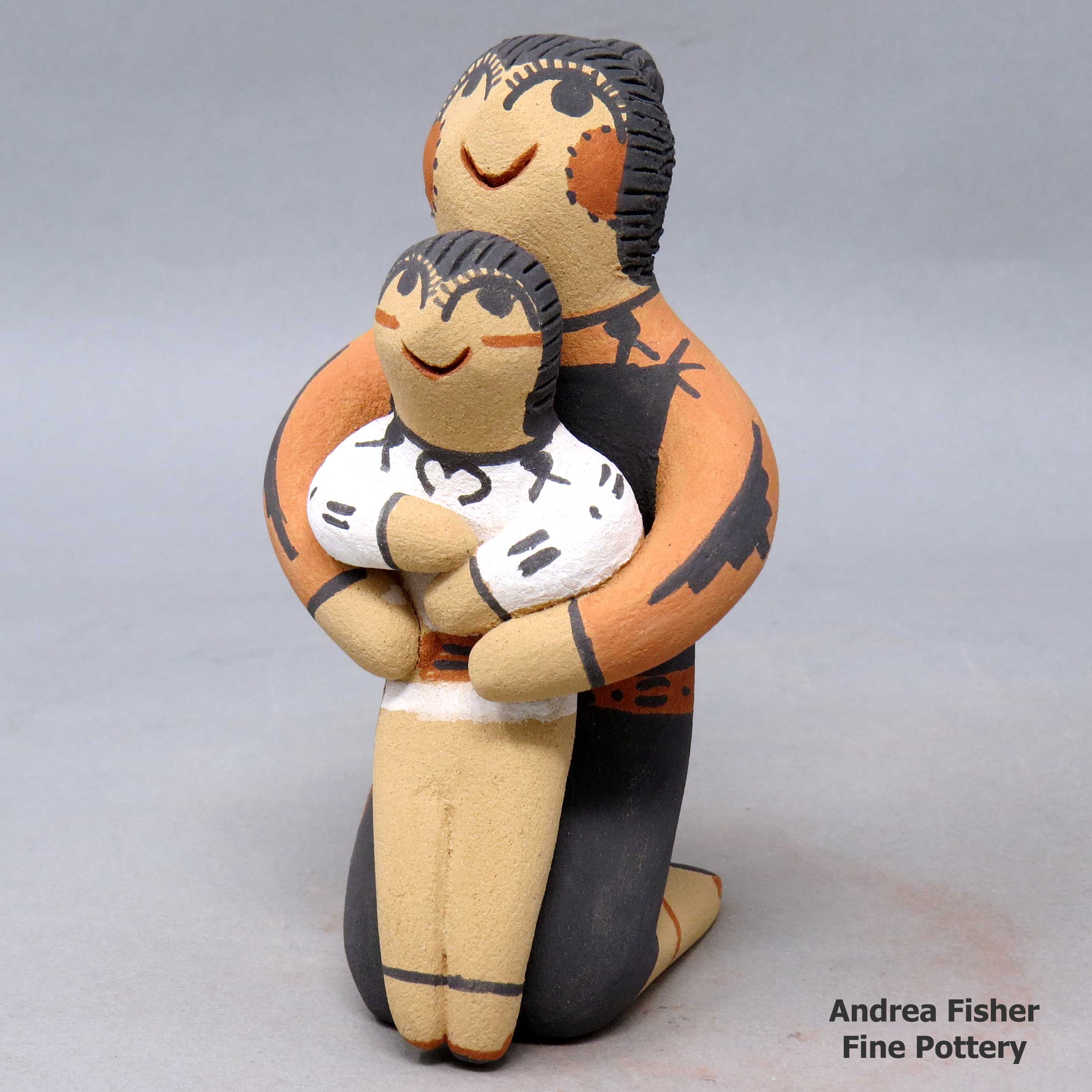 Click or tap to see a larger view Kneeling grandmother figure with 1 child
made by Clifford Kim Fragua of Jemez