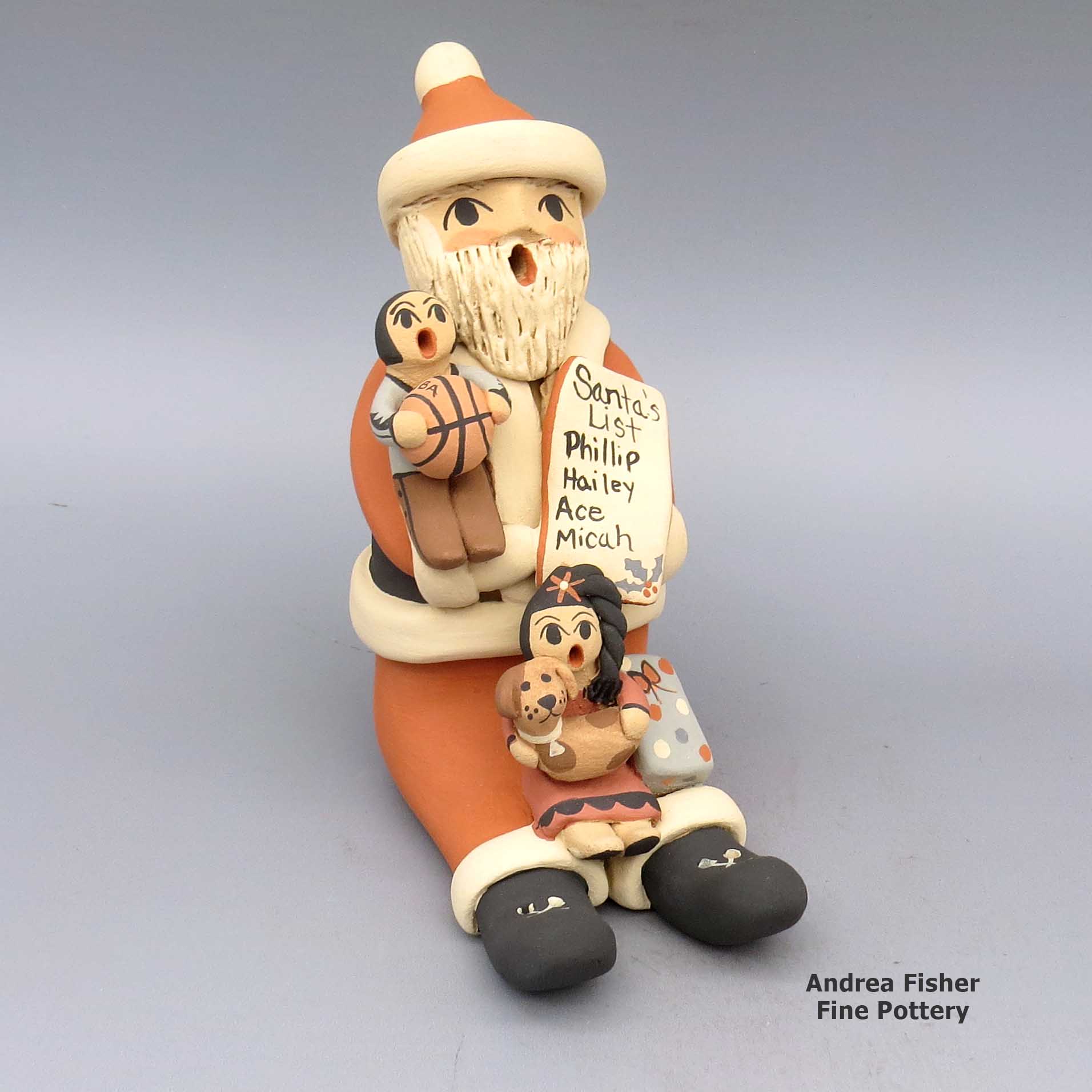 Click or tap to see a larger view Polychrome Santa Claus storyteller with two children, basketball, puppy, list, and present made by Chrislyn Fragua of Jemez