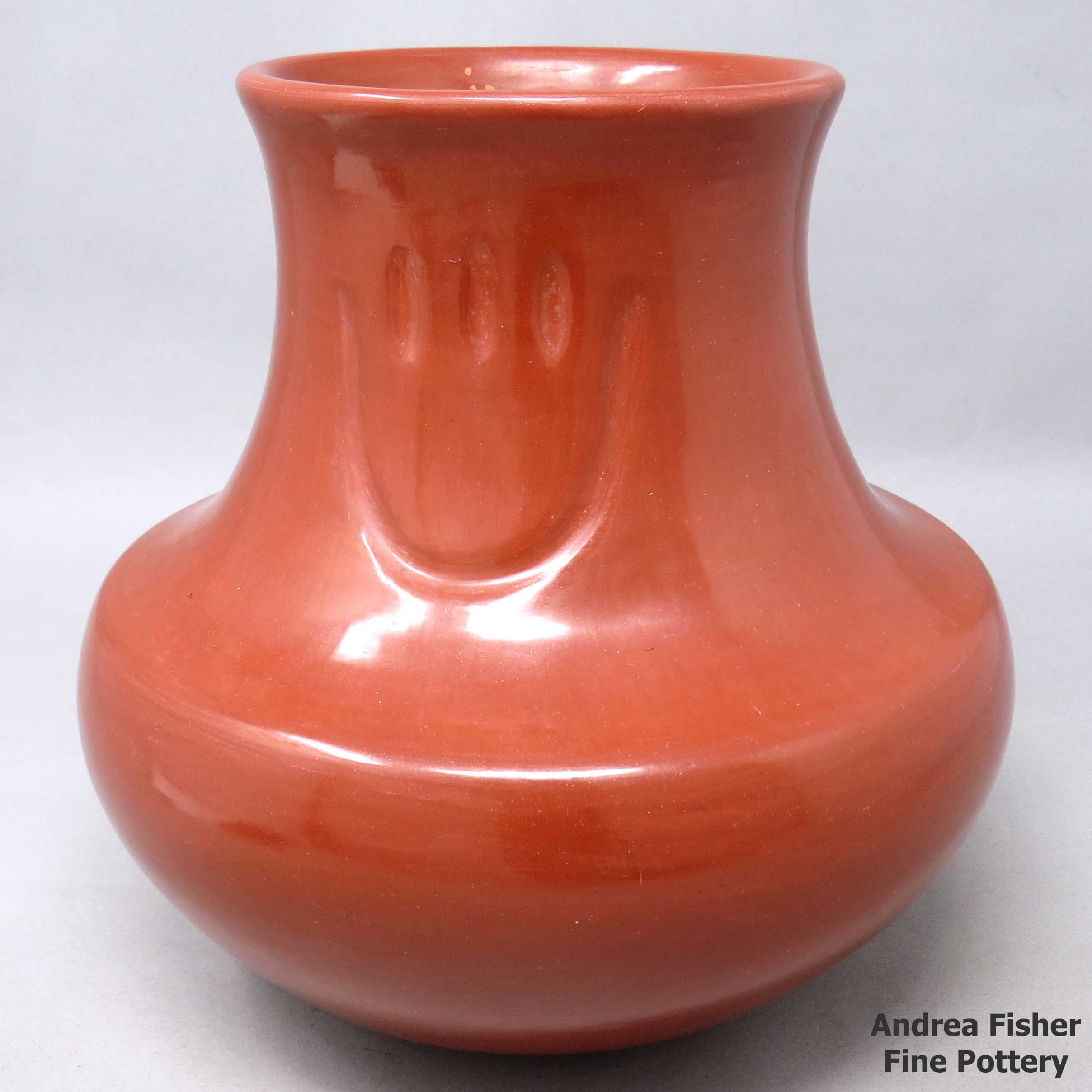 Click or tap to see a larger view Red jar with 2 bear paw imprints made by Tina Garcia of Santa Clara