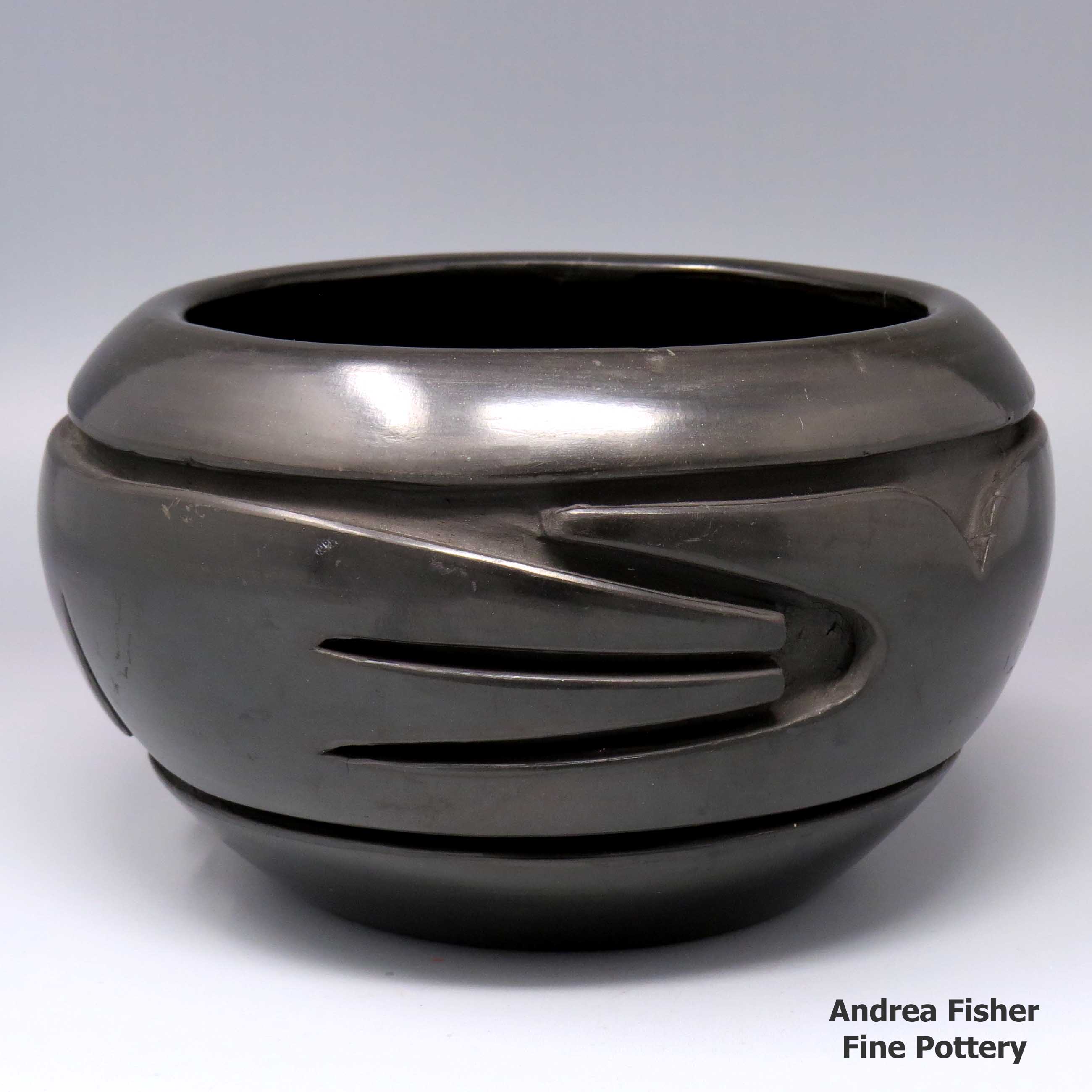 Click or tap to see a larger view Black bowl carved with a stylized avanyu design made by Stella Chavarria of Santa Clara