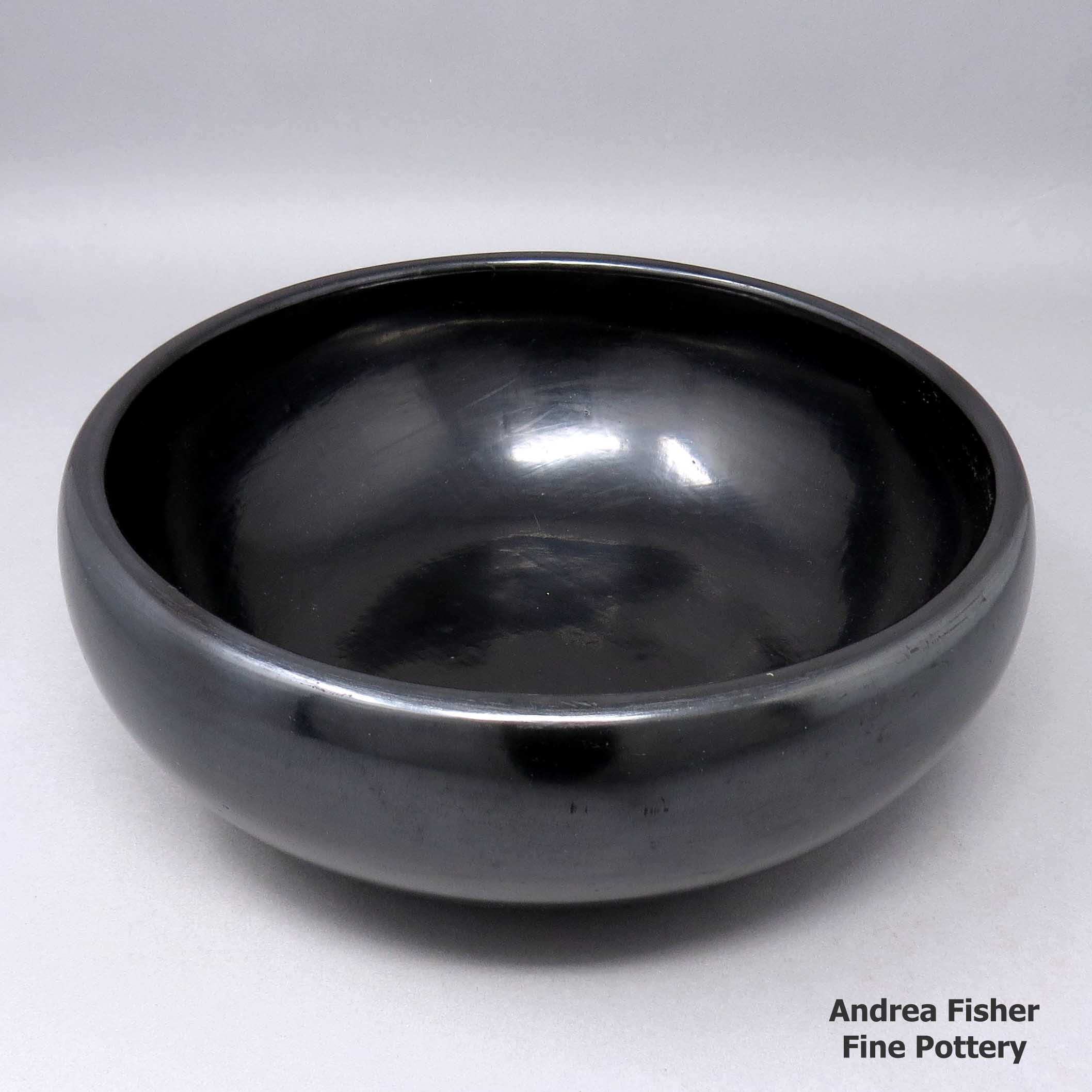 Click or tap to see a larger view Plain black bowl polished inside and out made by Rose Gonzales of San Ildefonso