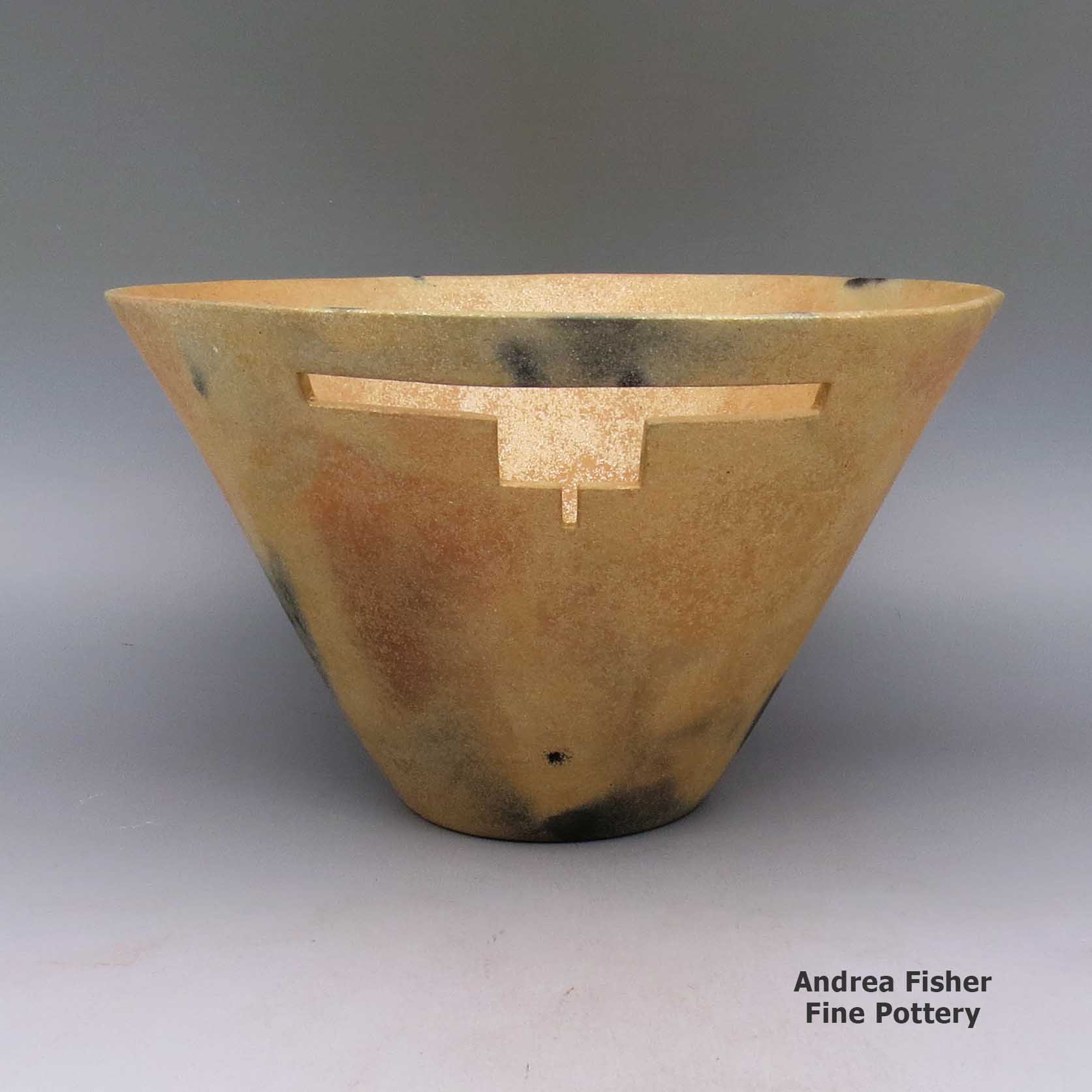 Click or tap to see a larger view Micaceous gold bowl with geometric cut out and fire clouds made by Angie Yazzie of Taos
