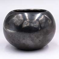 Polished black jar with dimpled bottom
 by Margaret Lou Gutierrez of San Ildefonso
