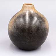 Small black and tan polished jar
 by Unknown of San Ildefonso