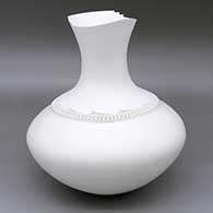 An elegant white vase with a sculpted organic opening and a band of lightly carved and sgraffito geometric design around the base of the neck
 by Wilfred Garcia of Acoma