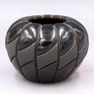 Black-on-black melon jar carved with 12 ribs and a geometric design
 by Anita Suazo of Santa Clara