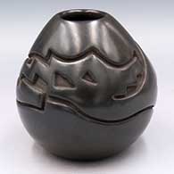 Black jar carved with an avanyu design
 by Eric Tafoya of Santa Clara