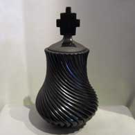 Lidded, polished black jar carved with swirl design 
 by Nancy Youngblood of Santa Clara