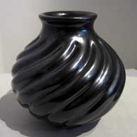 Black jar carved with swirl melon design 
 by Nathan Youngblood of Santa Clara