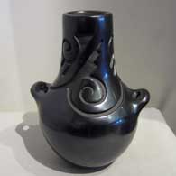 Tall neck black jar with handles and carved with kiva step, Tularosa spiral and geometric design 
 by Virginia Ebelacker of Santa Clara