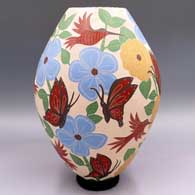 Polychrome jar with a sgraffito and painted butterfly, bird, flower, leaf and branch design
 by Blanca Arras of Mata Ortiz and Casas Grandes