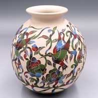 Polychrome jar with a rolled lip and a sgraffito and painted bird, flower, vine, leaf and geometric design
 by Diana Loya of Mata Ortiz and Casas Grandes