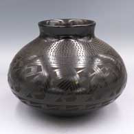 Black-on-black jar with a flared neck, a band of corrugation below the neck and a geometric design around the body
 by Armando Silveira of Mata Ortiz and Casas Grandes