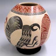 Polychrome jar with a sgraffito and painted 4-panel parrot design with an upper band of geometric design
 by Eleuterio Pina of Mata Ortiz and Casas Grandes