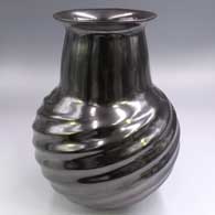 Glossy black jar with a flared lip and a formed spiral melon base
 by Alonso Sandoval of Mata Ortiz and Casas Grandes