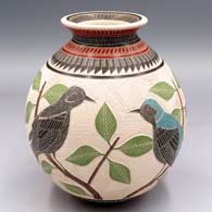 Polychrome jar with a flared rim and a lightly-carved, sgraffito and painted 2-panel bird, branch, leaf and geometric design
 by Jesus Olivas of Mata Ortiz and Casas Grandes