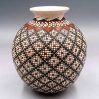 Polychrome jar with a rolled lip and a spiral cuadrillos and geometric design
 by Alma Flores of Mata Ortiz and Casas Grandes