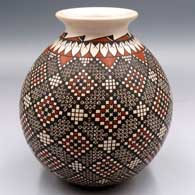 Polychrome jar with a rolled lip and a spiral cuadrillos and geometric design
 by Alma Flores of Mata Ortiz and Casas Grandes