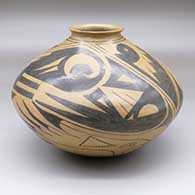 A brown jar with an everted lip and a black, four-panel bird and geometric design
 by Consolacion Quezada of Mata Ortiz and Casas Grandes