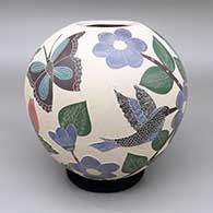 Polychrome jar with a sgraffito and painted hummingbird, butterfly, and flower design
 by Blanca Arras of Mata Ortiz and Casas Grandes