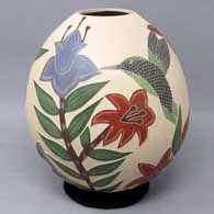 Polychrome jar with sgraffito and painted bird, butterfly, branch and flower design
 by Blanca Arras of Mata Ortiz and Casas Grandes
