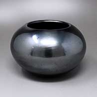 A plain polished gunmetal black jar
 by Maria Martinez of San Ildefonso