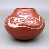 Red jar with a carved avanyu design
 by Linda Tafoya of Santa Clara