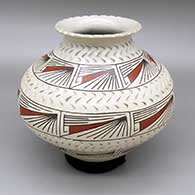 Polychrome jar with a flared opening and an indented and painted geometric design
 by Dora Quezada of Mata Ortiz and Casas Grandes