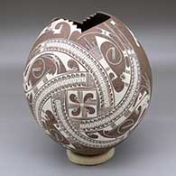 A mixed-clay jar with a geometric cut opening and a two-panel white geometric design
 by Lourdes Nunez of Mata Ortiz and Casas Grandes