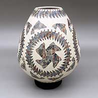 Polychrome jar with a sgraffito fish and feather geometric design
 by Leonel Lopez Sr of Mata Ortiz and Casas Grandes