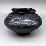 Black-on-black jar with a flared, square opening and an indented and painted geometric design
 by Oscar Quezada of Mata Ortiz and Casas Grandes