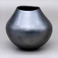 A plain micaceous black jar with an organic opening
 by Lonnie Vigil of Nambe