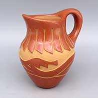 Red pitcher with carved avanyu and feather ring design
 by Ethel Vigil of Santa Clara