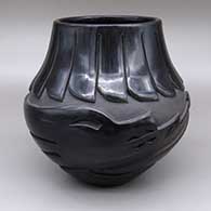 Black jar with a carved avanyu and feather ring geometric design
 by Judy Tafoya of Santa Clara