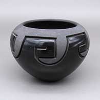 Black bowl with micaceous details and a carved geometric design
 by Madeline E Naranjo of Santa Clara