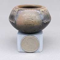 Miniature black bowl with a sienna rim and a sgraffito koshare, pueblo, avanyu, feather ring, bear paw, and geometric design
 by Kevin Naranjo of Santa Clara