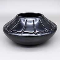 Black jar with a carved feather ring design
 by Toni Roller of Santa Clara