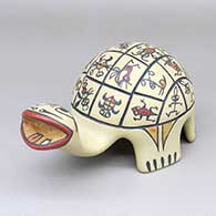 A polychrome turtle figure with a lightly carved-and-painted insect, bird, fish, sea turtle, dragonfly, deer, frog, lizard and geometric design on shell
 by Margaret Gutierrez of Santa Clara