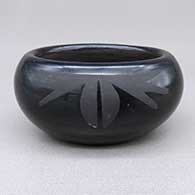 Small black-on-black bowl with an oval shape and a geometric design
 by Pauline Martinez of San Ildefonso